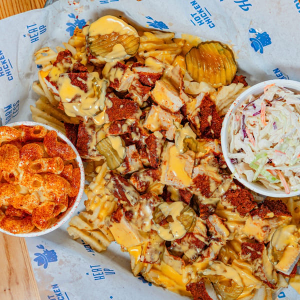 Howdy Hot Chicken's loaded waffle fries with chicken, cheese sauce, pickles, mac and cheese, and coleslaw.